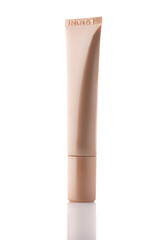 Cosmetic tube on a white background. Decorative cosmetics. A tube of foundation, concealer, liquid shadows.