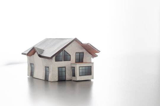Model of house painted white under the tiled roof