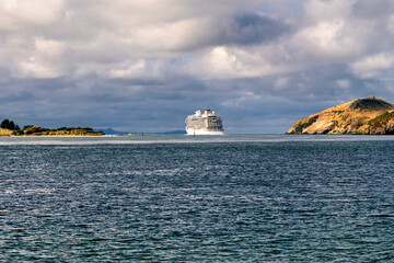 Cruise ship sails out of the bay to the ocean - obrazy, fototapety, plakaty