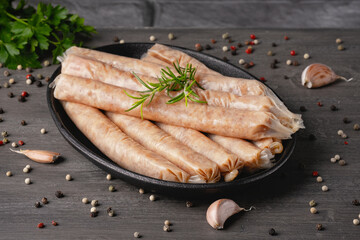 Freshly made raw chicken sausages in skins for grilling and barbecue