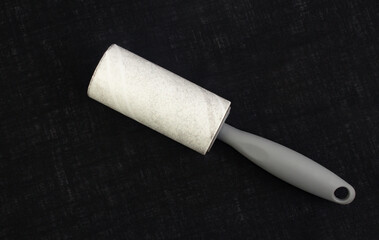 Hair removal roller on black fabric