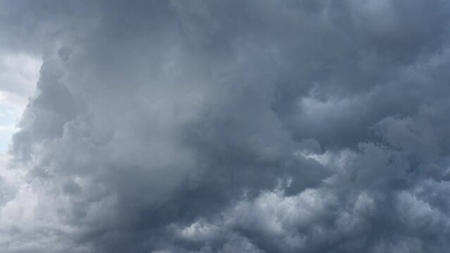 Dark stormy clouds time-lapse with brightening sky