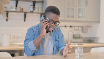 Annoyed Young Businessman Talking on Phone