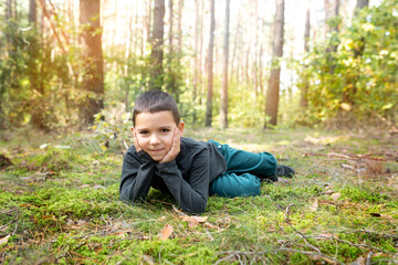 child in an old pine forest. Walk in the fresh forest air.