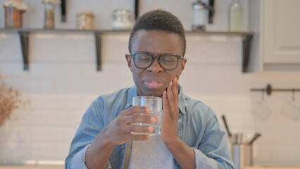 Young African Man Having Toothache while Drinking Water