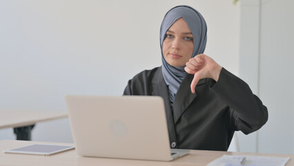 Thumbs Down by Arab Businesswoman Working on Laptop