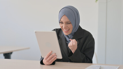 Arab Businesswoman Celebrating Success on Tablet PC