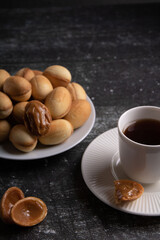photo sandy candy with condensed milk and a cup of coffee
