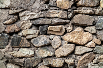 Background of natural stones bonded with cement mortar.