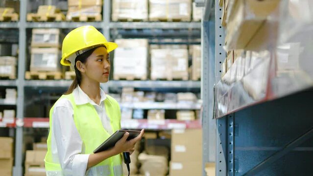 Female employee worker scanning products on shelves in warehouse, working with scanner for merchandise distribution. Young adult reviewing stock logistics before order shipment in depot, slow motion