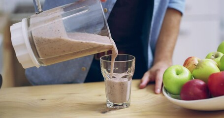 Blender, healthy food and smoothie with hands of a man in home kitchen with a drink for health, nutrition or protein. Male person with a fruit cocktail in a glass for wellness, detox and vegan diet