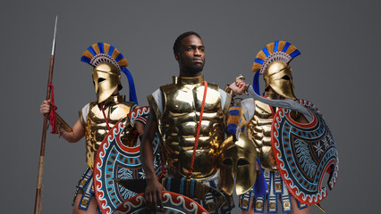 Studio shot of multiethnic group of three soldiers from ancient greece.