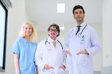 Smiling medical team standing inside the hospital.