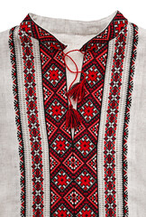 Handmade vyshyvanka shirt embroidered with red and black threads. Top shot, vertical orientation. Vyshyvanka Day, Embroidery Day concept