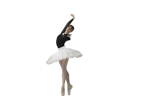 ballerina in a black bodysuit and tutu poses in motion showing ballet elements while standing on pointe shoes