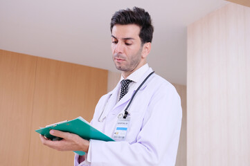 male doctor standing patient file.