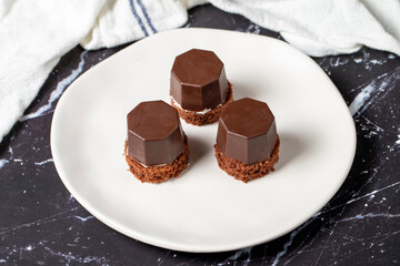Cookies covered in milk chocolate. Liquid chocolate chip cookies on a dark background