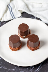 Cookies covered in milk chocolate. Liquid chocolate chip cookies on a dark background. Close up