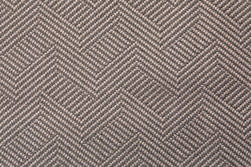 Knitted texture. Texture of jacquard fabric with gray geometric pattern. Crochet mosaic pattern.