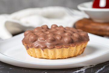 Obraz na płótnie Canvas Chocolate pie. Hazelnut, cream and chocolate pie on dark background. Close up