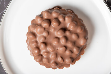 Chocolate pie. Hazelnut, cream and chocolate pie on dark background. Close up. Top view