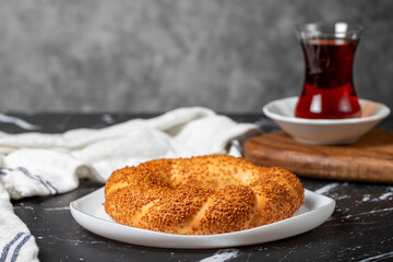 Sesame bagel on dark background. Turkish street food circular bread, bagel with sesame. Simit or gevrek.