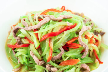 Fried meat with shredded lettuce on a plate on a white background