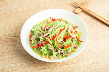 A home-cooked dish lettuce shredded fried meat on the table