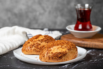Sesame and cheese pastry on dark background. Turkish street food. Peynirli pogaca. Close up