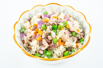 A plate of homemade colorful meat fried rice on a white background