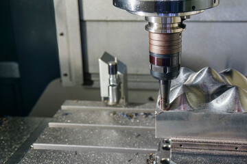 The CNC milling machine rough cutting the mold parts by indexable ball tools.