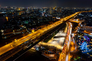 Fototapeta na wymiar Expressway top view, Road traffic an important infrastructure, Drone aerial view fly in circle, traffic transportation, Public transport or commuter city life concept of economic and energ, transport.