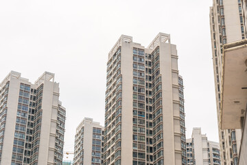 Fototapeta na wymiar Beihai, China - July 18, 2019: Modern Chinese Apartment Building With Balconies in Residential Area