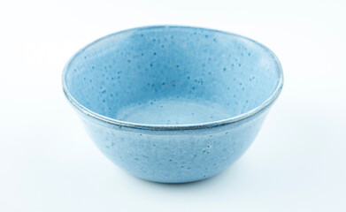 A blue ceramic bowl on a white background