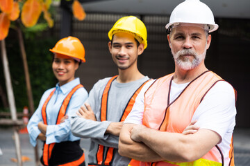 Arms crossed. Professional team working at workplace. Unity and teamwork concept. Portrait engineer factory manager worker and mechanic team together in factory workplace