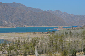 big river with huge mountains in the background in broad daylight