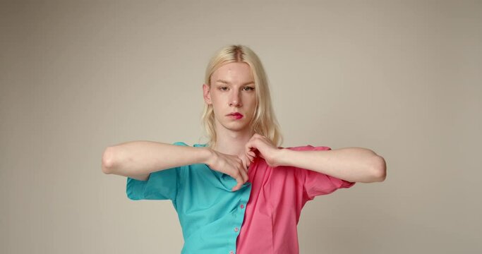 Fashinable non binary man posing on camera on color background