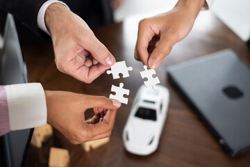 Group of diverse business people assembling jigsaw puzzle. Unity and teamwork concept