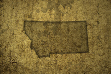 map of montana state on a old vintage crack paper background .