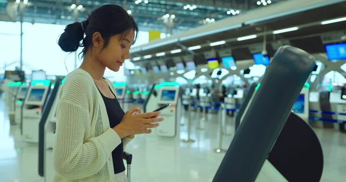Asian woman checking tickets in the airport. Travel, Lifestyle, Backpack, Vacation and Holiday concept.