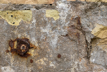 Close-up of a rusty plate on an old brick wall, texture