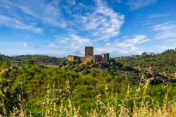 Fototapeta na wymiar Beautiful castle of Belver in a hill by the margins of the Tagus River. Alamal beach in the margins of the Tagus River - Portugal