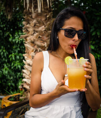 woman drinking chelada cocktail