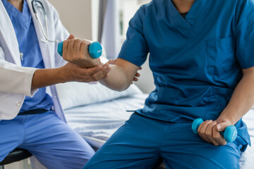 Using dumbbell, Physiotherapy specialists help patients in physiotherapy. about Muscle Weakness and Fatigue