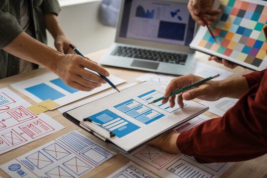 Group of asian creative team programing designers participate in all phases of the UX design.