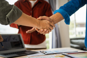 Shaking hands, Group of asian creative team programing designers participate in all phases of the UX design.