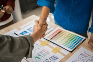Shaking hands, Group of asian creative team programing designers participate in all phases of the UX design.