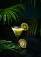Fresh kiwi juice with green leaves isolated on black background, Creative Juice photography image