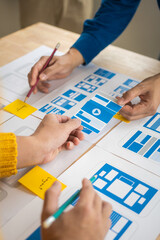 Group of asian creative team programing designers participate in all phases of the UX design.