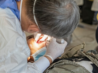 Close up of a dentist working on a patient's teeth in a dental clinic